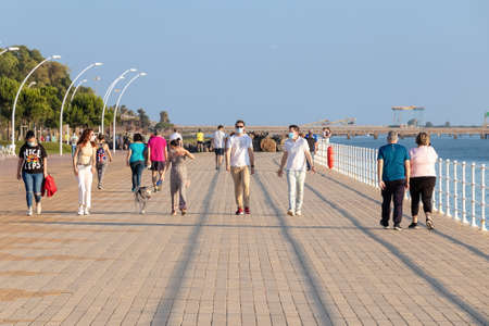 Huelva, Spain - May 5, 2020: People going out for a walk wearing protective or medical face masks during the alarm state and quarantine in Spain.のeditorial素材