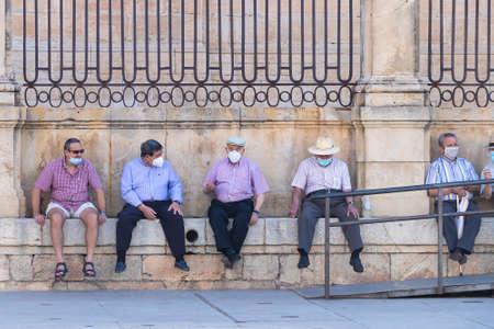 Jaen, Spain - June 18, 2020: A group of old friends wearing protective or medical face masks during the alarm state and quarantine in Spain.のeditorial素材