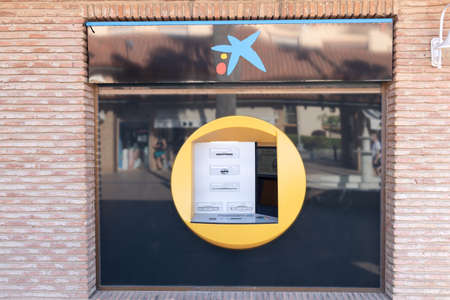 Huelva, Spain - July 4, 2020: ATM machine of Caixabank bank in the Islantilla beach mallのeditorial素材