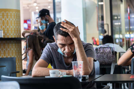 Lagoa, Portugal - July 11, 2020: A couple of women paddle surfing in benagil caves over turquoise watersのeditorial素材