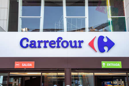 Huelva, Spain - July 27, 2020: Carrefour logo above the store entrance in Holea Shopping center. Carrefour S.A. is a French multinational corporation specialized in retail.のeditorial素材