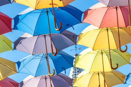 The sky is full of colorful umbrellas. Street with umbrellas in the sky in the village San Bartolome...