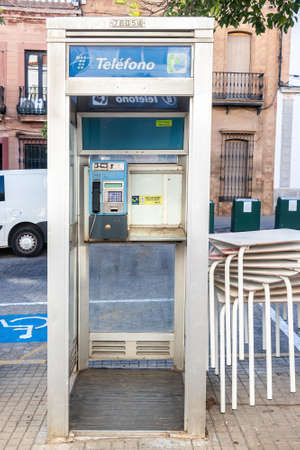 Huelva, Spain - August 16, 2020: Phone booth from Telefonica company in the town center pf Valverde del Camino. One of old and useless public phones that remains in public ways in Spainのeditorial素材