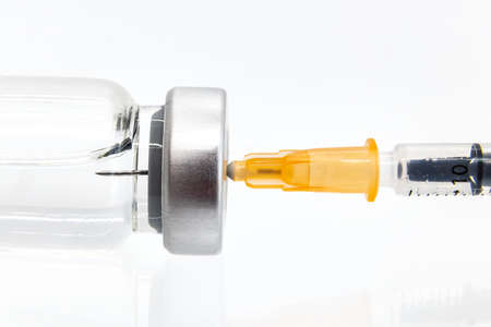 Vaccine in vial with syringe isolated on white background