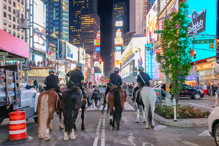 New York City, USA - June 7, 2017: NYPD police officers on horseback in Times Square, New York City. Mounted Police patrolling the night in Times Squareのeditorial素材
