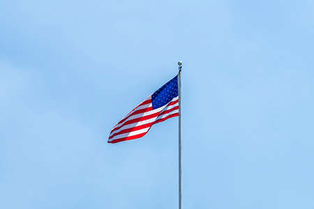 United States of America Flag over a clear blue sky backgound