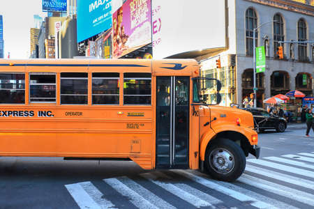 New York City, USA - June 7, 2017: School bus turning right in Times Squareのeditorial素材