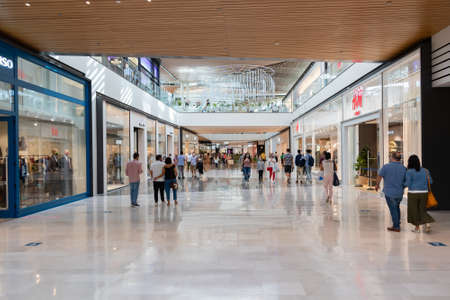 Seville, Spain - September 18, 2020: People shopping inside Lagoh Sevilla shopping mall wearing protective face masks due to coronavirus covid-19. Lagoh Shopping Center Sevilla, Andalusia, Spainのeditorial素材