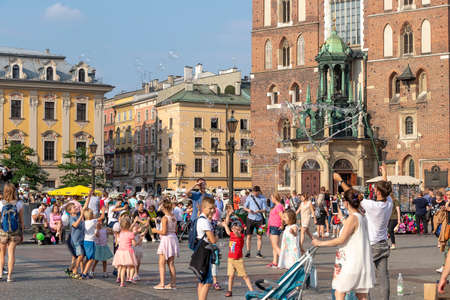Krakow, Poland June 5, 2018: Kids play with soap bubble in the main square of the Old Town of Krakow, Lesser Poland, is the principal urban space located at the center of the city. It dates back to the 13th centuryのeditorial素材