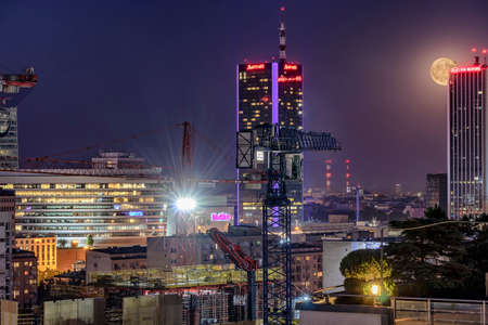 Warsaw, Poland May 30, 2018: Night panorama of Warsaw with new constructions, at night with moon rising from behind of a skyscraperのeditorial素材