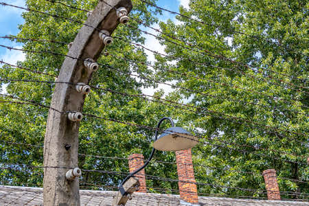 Electric fence with barbed wire and an old lampのeditorial素材