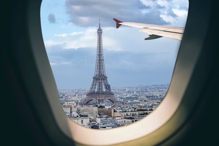 Aerial view Paris cityscape through airplane window while approaching to airportのeditorial素材