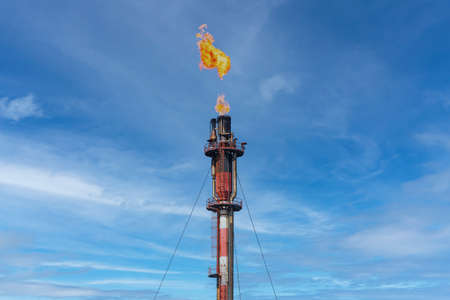 Exhaust chimney of the petrochemical industry with the burning flame of Palos de la Frontera in...