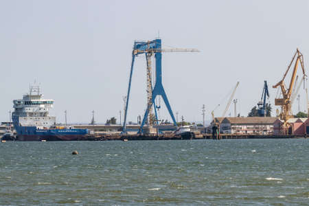 Huelva, Spain - August 3, 2021: Shipyards of Huelva with a ship under repair and the view of cranesのeditorial素材