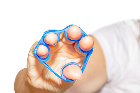 Hand Grip Strengthener in blue in the hand of a woman isolated on white backgroundの写真素材