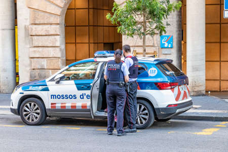 Tarragona, Spain - September 23, 2021: Catalunya police (mossos d'esquadra) remove a detainee from...