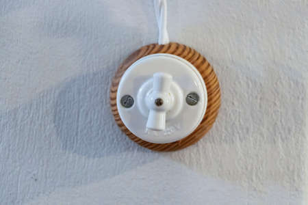 Old round twist-actuated light switch