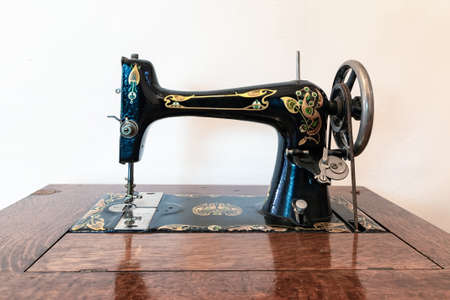 Old sewing machine in wooden furnitureの写真素材