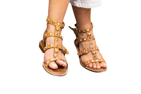 Feet of a woman with sandals isolated on white backgroundの写真素材
