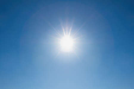Sun in a clear blue sky for backgroundの写真素材