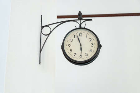 old wall clock over a white wallの写真素材