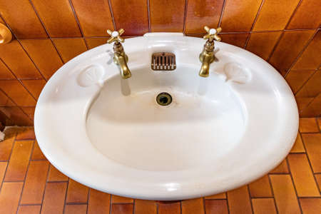 Antique washbasin with bronze taps