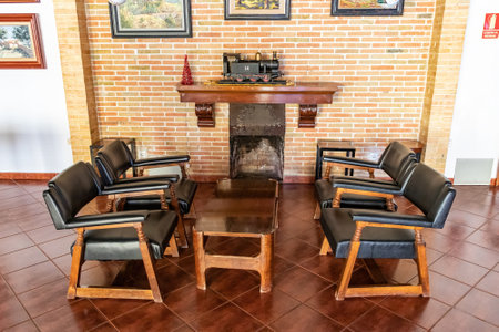 Old english style room from early 20th century with a fireplace and a steam train over the mantelのeditorial素材