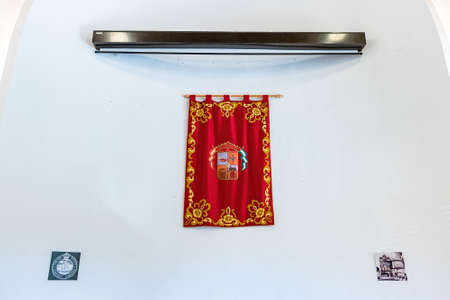 Huelva, Spain - December 18, 2021: Banner with the coat of arms of the town of Minas de Riotinto hanging on the wall of the old Anglican Church used by the staff of the Rio Tinto Company Limitedのeditorial素材