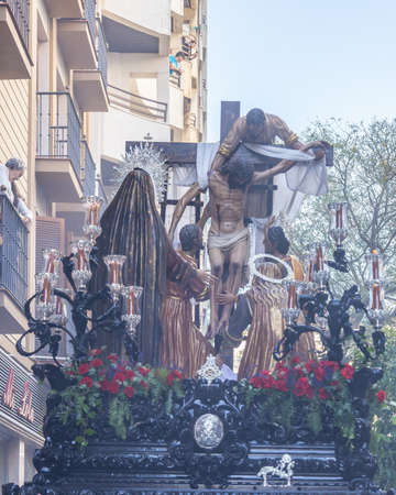 Huelva, Spain - April 15, 2022: Throne or platform of Descendimiento (descent) in procession by the narrow streets of the city. Soft focus due to the smoke of censeのeditorial素材