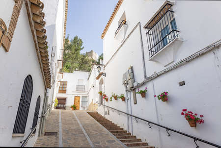 Typical narrow street in Zahara de la Sierra, in Sierra de Grazalema, Cadiz, Andalusia, Spainの写真素材