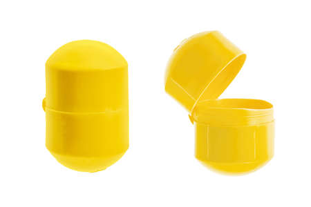 Yellow surprise capsule, egg shaped, isolated on white backgroundの写真素材