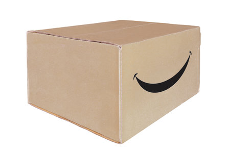 Closed cardboard box with a smile sign, isolated on a white background.の写真素材