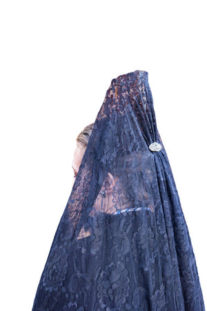 Detail of the head of a woman with a black Spanish mantilla and peineta (ornamental comb), seen from behind, in a Holy Week procession. Isolated on white backgroundの写真素材