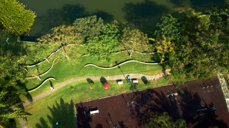 Drone top down view aerial photograph of a Malaysian eco park during the evening with public exercise equipmentsの写真素材