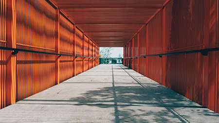 A walkway with covered with metallic bars