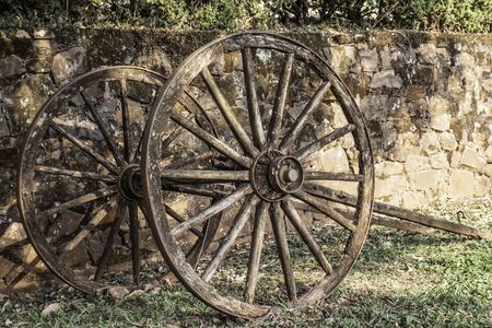 wagon wheel parking on grass with stone wall background in Brazilの写真素材