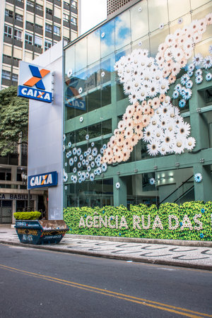 Curitiba, Parana, January 03, 2018. Caixa Economica Federal Government Bank Logo on Agency Entrance in Flores street, downtown in downtown of Curitiba, Parana stateのeditorial素材