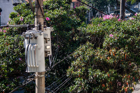 Electric power transformer on a public lighting pole on street in Brazil