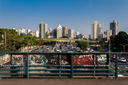 SÃ£o Paulo, Brazil, September 23, 2015: Traffic on the famous 23 de Maio Avenue in Sao Paulo, Brazil. This avenue run past Ibirapuera Park. A graffiti art on the structure.のeditorial素材
