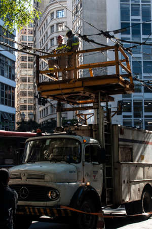 Sao Paulo, Brazil, May 29, 2012. worker maintains of electricity cables from the trolleybus network at Se Square, in downtown Sao Pauloのeditorial素材