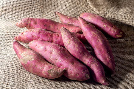 Red sweet potato pile on jute background in Brazilの写真素材