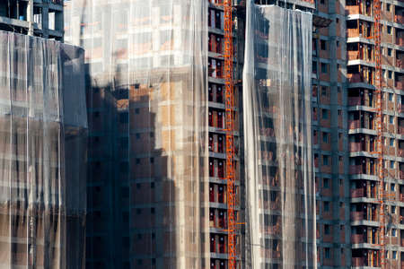 Residential building construction site with net protection and outdoor elevator in Sao Paulo cityの写真素材