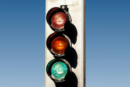 Equipment for regulating transport with blue sky background. The traffic lights controlling cars and...