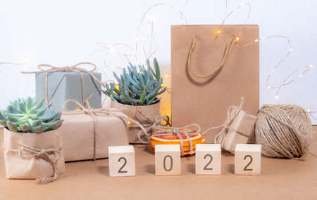 Year 2022 written on wooden cubes Christmas background craft style