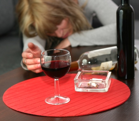 lonely and desperate - portrait of middle-aged woman with addiction problems の写真素材