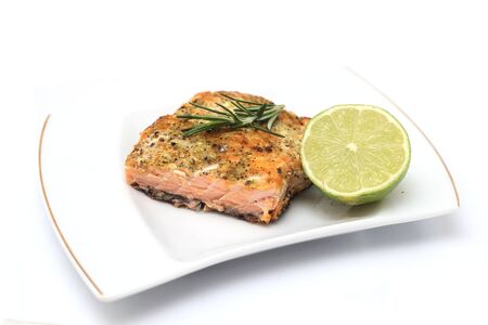  grilled salmon steak over white plate 