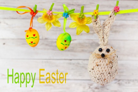 easter eggs, rabbit and flowers hanging on the ribbon