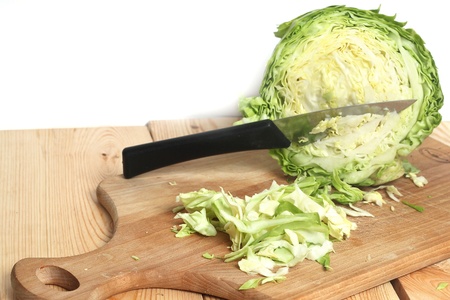 green cabbage shredded on wooden boardの写真素材