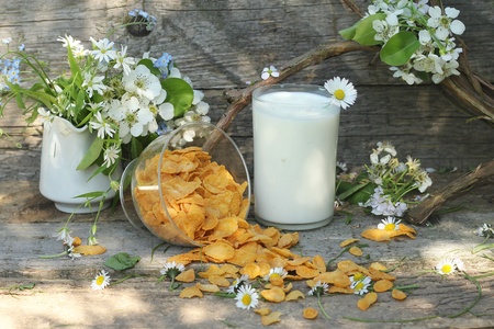 tasty cornflakes on wooden background