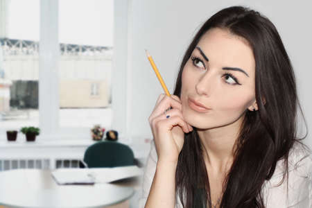 Beautiful business woman on the background in the officeの写真素材